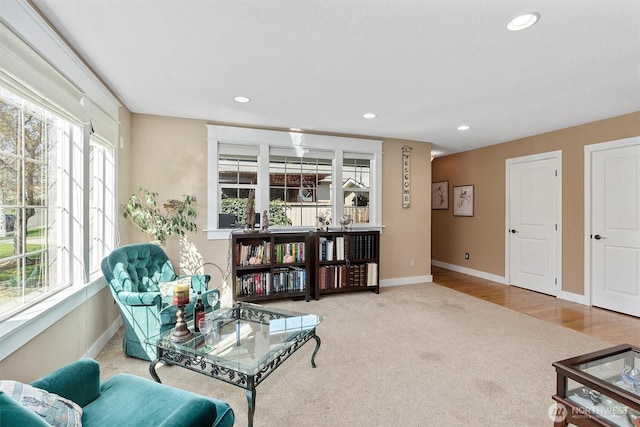 living area featuring baseboards, carpet floors, and recessed lighting
