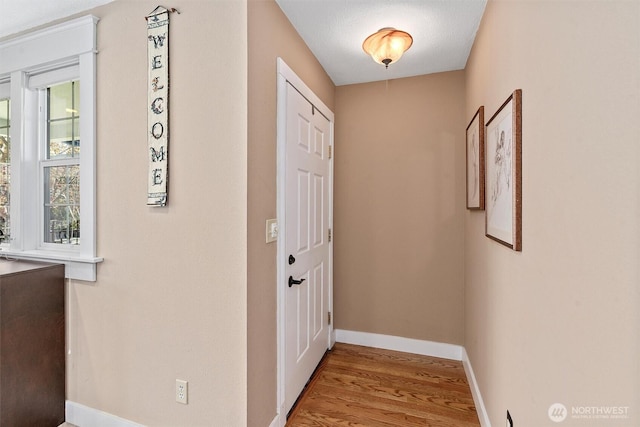 interior space with wood finished floors and baseboards