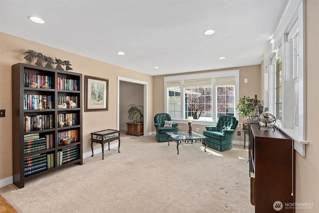 living area featuring recessed lighting, baseboards, and carpet