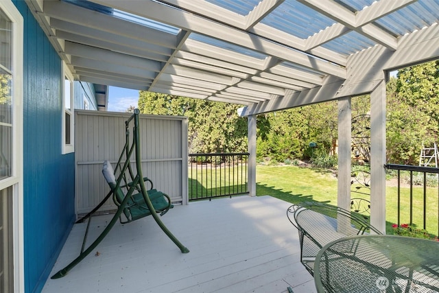 wooden deck with a lawn and a pergola