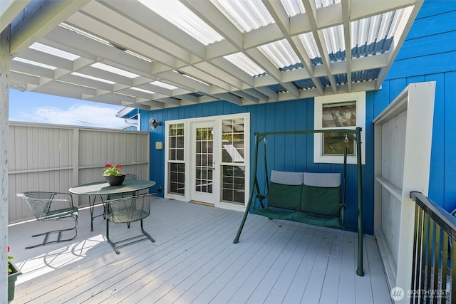 wooden deck featuring outdoor dining area and a pergola