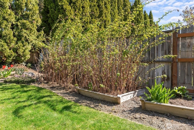 view of yard featuring a garden and fence