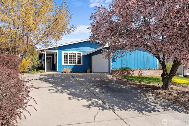 view of front facade featuring concrete driveway and a garage