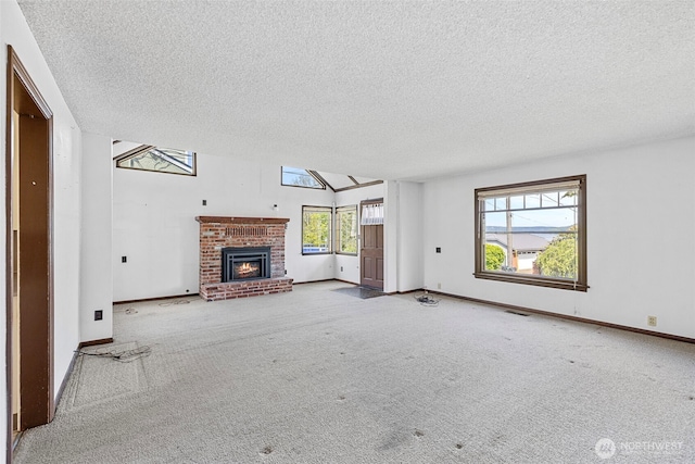 5323 Hyada Blvd NE, Tacoma, WA 98422 - unfurnished living room with carpet floors, a brick fireplace, a textured ceiling, and visible vents