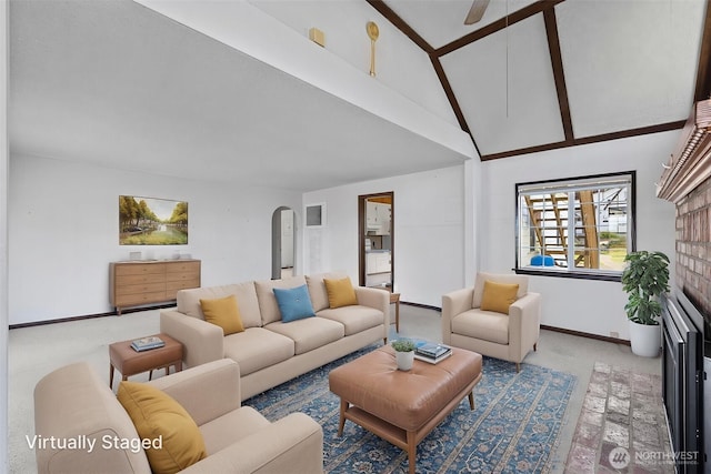 5323 Hyada Blvd NE, Tacoma, WA 98422 - carpeted living area featuring a ceiling fan, beam ceiling, baseboards, high vaulted ceiling, and arched walkways