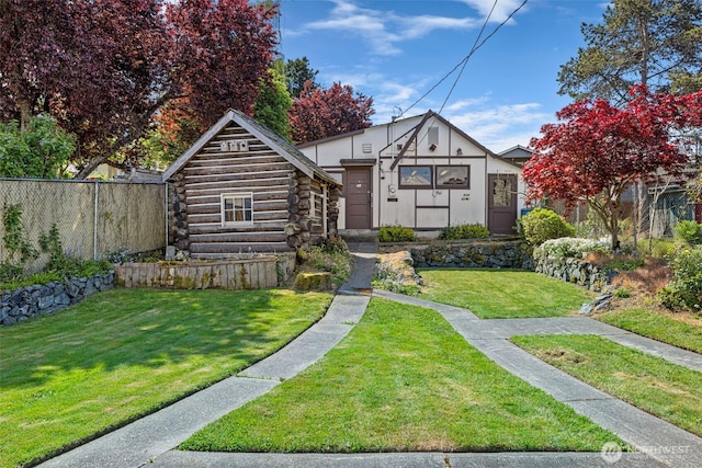 5323 Hyada Blvd NE, Tacoma, WA 98422 - view of front facade featuring a front lawn, fence, and log siding