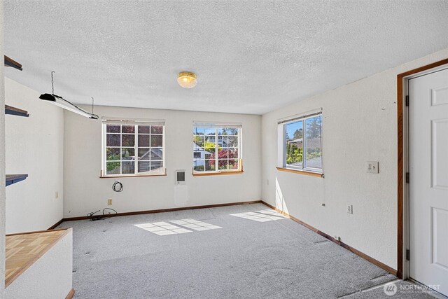 5323 Hyada Blvd NE, Tacoma, WA 98422 - spare room featuring a textured ceiling, baseboards, and carpet