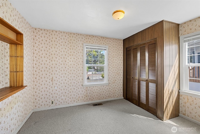 5323 Hyada Blvd NE, Tacoma, WA 98422 - unfurnished bedroom with visible vents, a closet, baseboards, wallpapered walls, and carpet flooring
