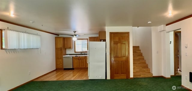 500 N Duckabush Dr W, Hoodsport, WA 98548 - kitchen featuring freestanding refrigerator, stainless steel dishwasher, brown cabinets, light colored carpet, and ornamental molding