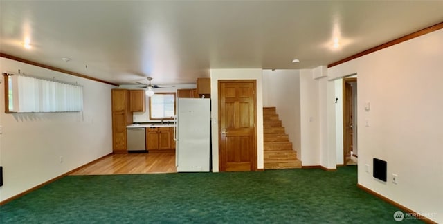 500 N Duckabush Dr W, Hoodsport, WA 98548 - kitchen with freestanding refrigerator, stainless steel dishwasher, light carpet, brown cabinets, and baseboards