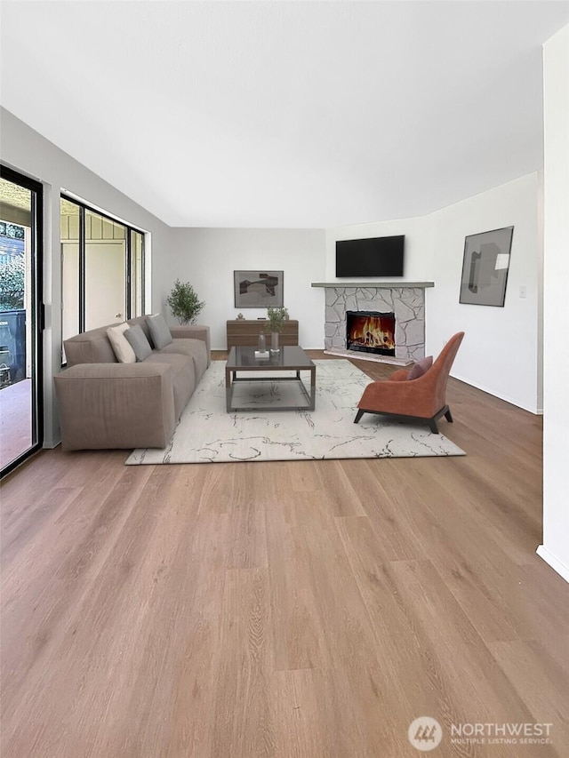 3435 Auburn Way S Unit 9, Auburn, WA 98092 - living area featuring a stone fireplace and wood finished floors