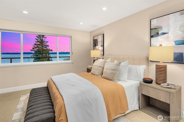 bedroom featuring baseboards, carpet flooring, recessed lighting, and a water view