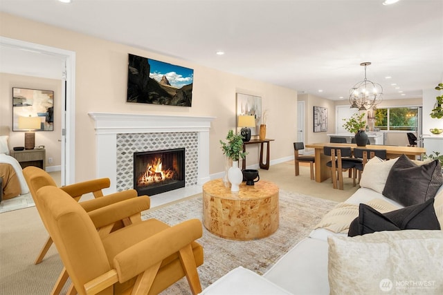 living room with recessed lighting, a chandelier, carpet, and a tile fireplace