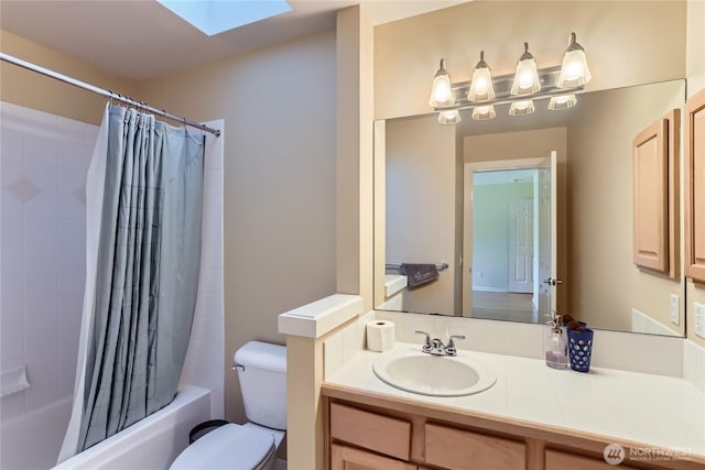 full bathroom with shower / tub combo, toilet, vanity, and a skylight