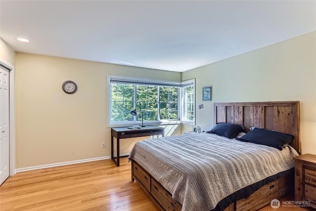 bedroom with light wood-type flooring, baseboards, and recessed lighting