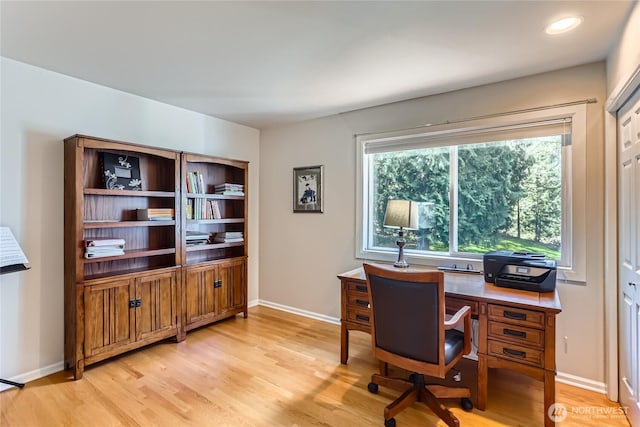 home office with baseboards and light wood-style floors