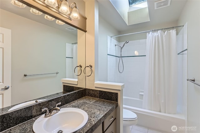bathroom with shower / bath combo with shower curtain, vanity, visible vents, and a skylight
