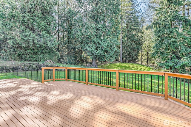 wooden deck with a lawn