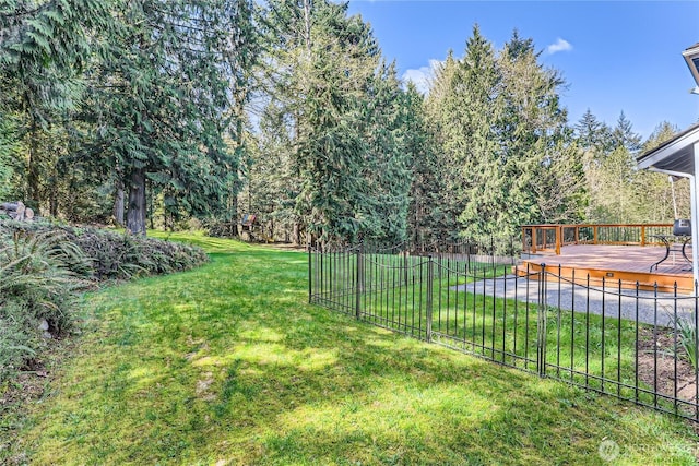 view of yard with fence and a deck