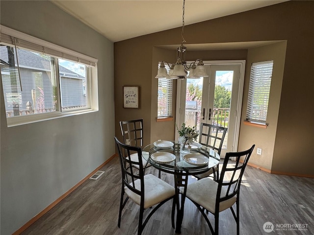 dining space featuring a chandelier, visible vents, a wealth of natural light, and baseboards