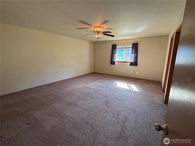 unfurnished room with baseboards, a ceiling fan, and carpet floors