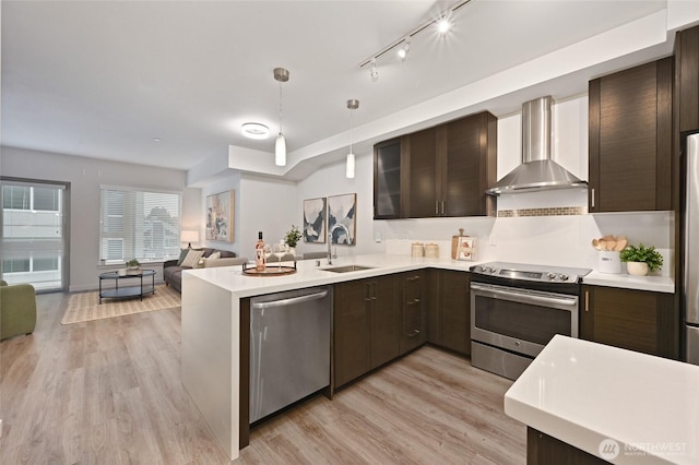 1760 NW 56th St Unit 601, Seattle, WA 98107 - kitchen featuring wall chimney exhaust hood, stainless steel appliances, light countertops, and a sink