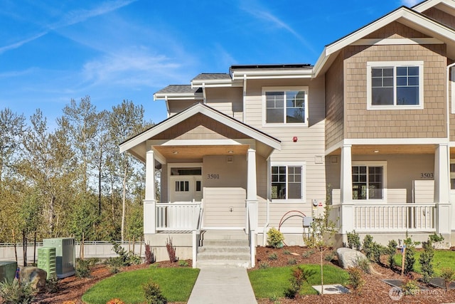 view of front of property with solar panels and a porch