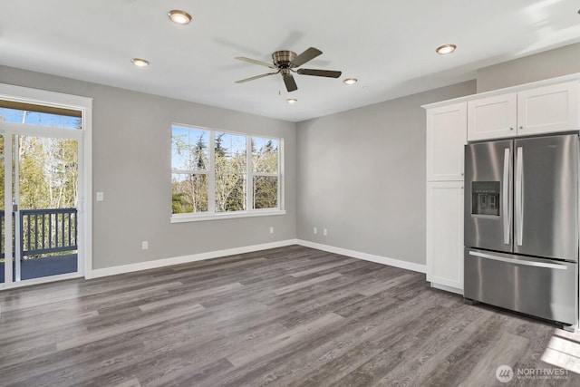 unfurnished living room with dark wood-style flooring and a healthy amount of sunlight