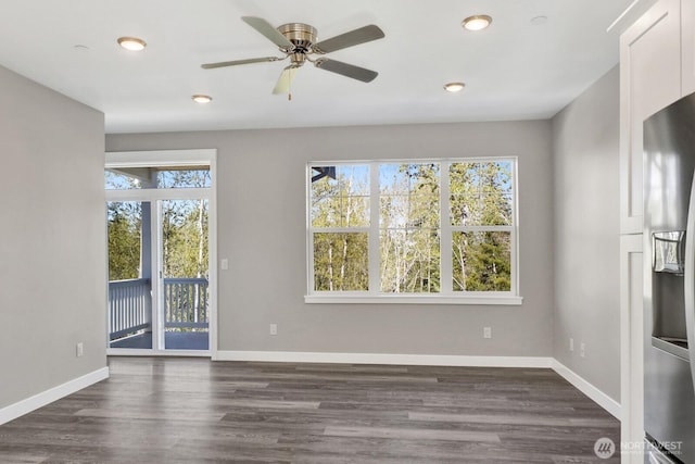 unfurnished living room with baseboards, dark wood-style floors, and recessed lighting