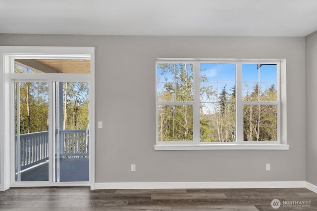 interior space with baseboards and wood finished floors