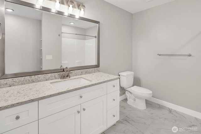 bathroom with vanity, marble finish floor, a shower, baseboards, and toilet