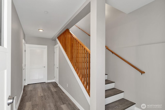 stairway featuring wood finished floors and baseboards