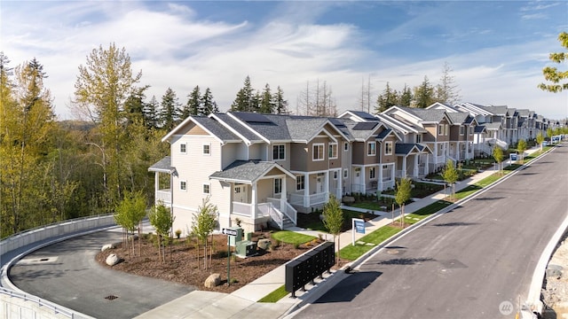 view of road featuring curbs, sidewalks, and a residential view