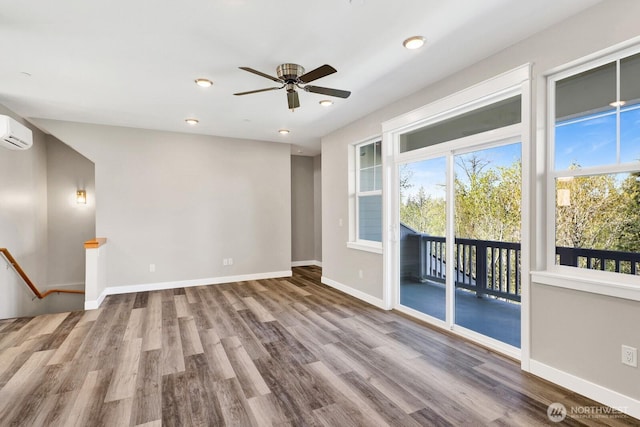 3513 Sussex Dr, Bellingham, WA 98226 - empty room featuring wood finished floors, recessed lighting, a wall mounted AC, a ceiling fan, and baseboards