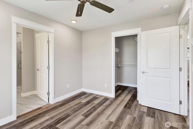 3513 Sussex Dr, Bellingham, WA 98226 - unfurnished bedroom featuring a closet, baseboards, and wood finished floors