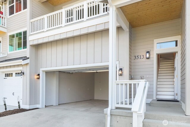 3513 Sussex Dr, Bellingham, WA 98226 - property entrance with driveway, a garage, and board and batten siding