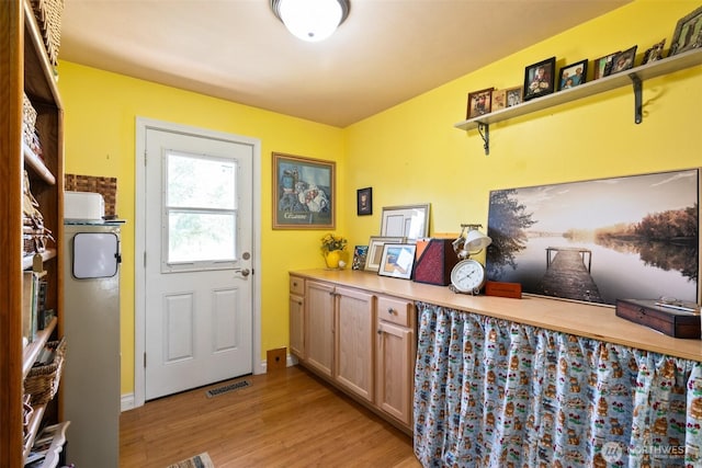 doorway to outside featuring light wood-style flooring and visible vents