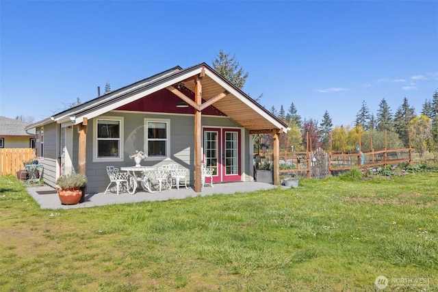 rear view of house with a yard, a patio area, and fence