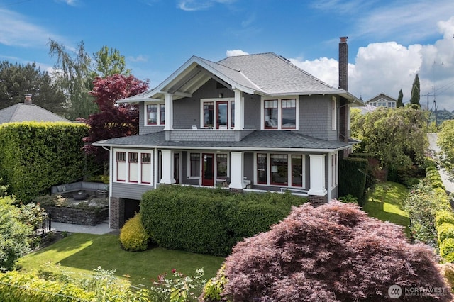 4015 S Andover St, Seattle, WA 98118 - view of front of home featuring a chimney, a front lawn, and roof with shingles