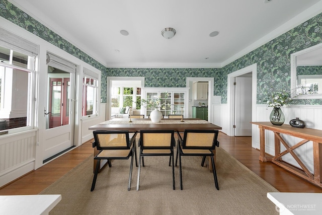 4015 S Andover St, Seattle, WA 98118 - dining space with wallpapered walls, wood finished floors, wainscoting, and crown molding
