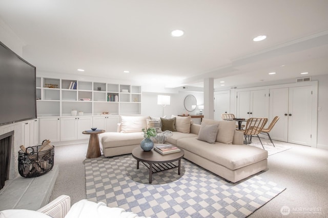 4015 S Andover St, Seattle, WA 98118 - living room featuring recessed lighting, light colored carpet, and a fireplace with raised hearth