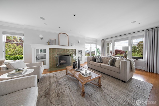 4015 S Andover St, Seattle, WA 98118 - living area with wood finished floors, crown molding, and a tiled fireplace