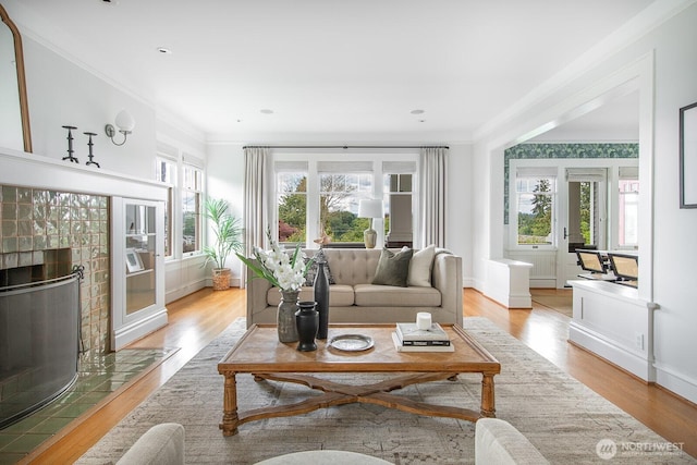 4015 S Andover St, Seattle, WA 98118 - living area featuring crown molding, light wood-style floors, a fireplace, and baseboards