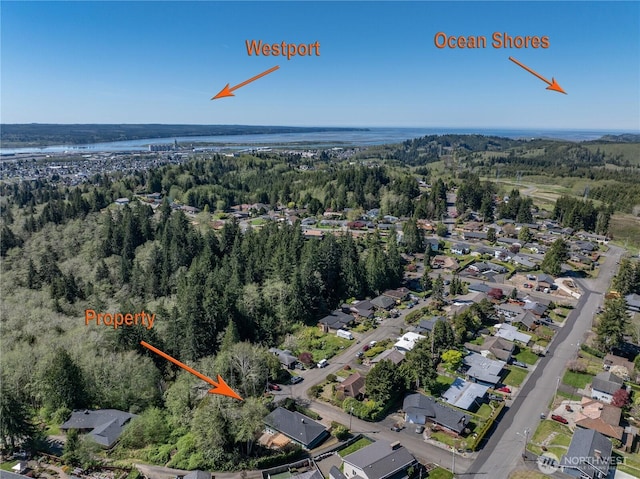 birds eye view of property featuring a water view, a residential view, and a view of trees