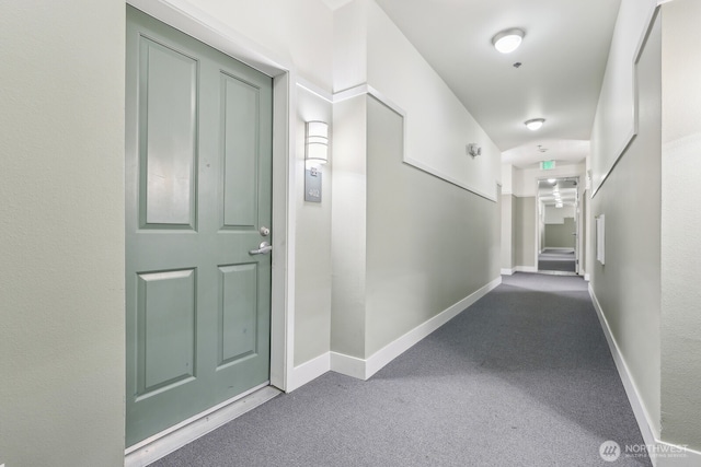 corridor with carpet flooring and baseboards
