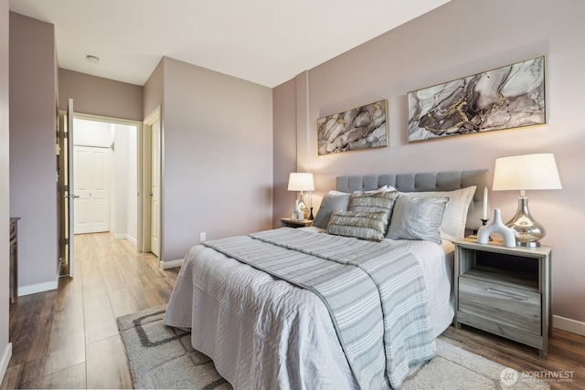 bedroom featuring baseboards and wood finished floors