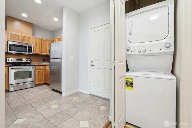 interior space featuring laundry area, stacked washing maching and dryer, recessed lighting, baseboards, and light tile patterned floors