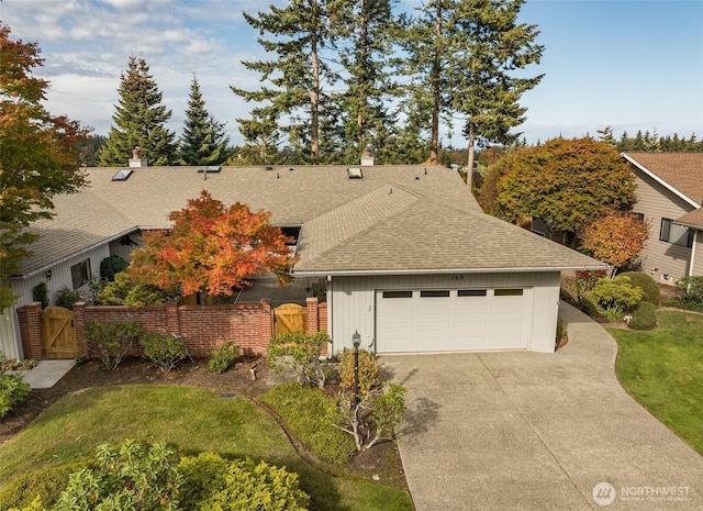169 Fairway Dr, Sequim, WA 98382 - single story home featuring a gate, fence, driveway, roof with shingles, and a garage