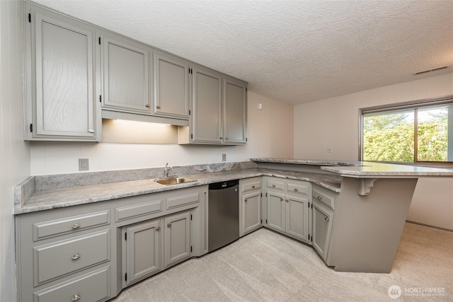 169 Fairway Dr, Sequim, WA 98382 - kitchen with dishwasher, a sink, gray cabinetry, a peninsula, and light colored carpet
