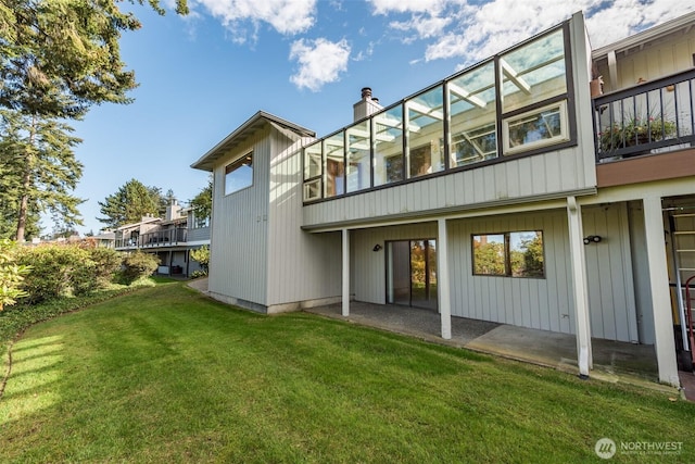 169 Fairway Dr, Sequim, WA 98382 - back of property featuring a lawn, a balcony, a chimney, and a patio
